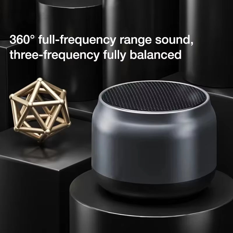 Compact black wireless speaker with 360° sound and balanced three-frequency audio on black cylindrical stands