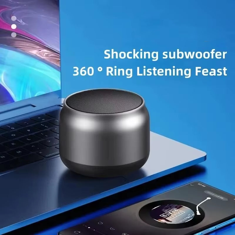 Compact metallic wireless subwoofer on laptop with text highlighting 360° ring listening experience